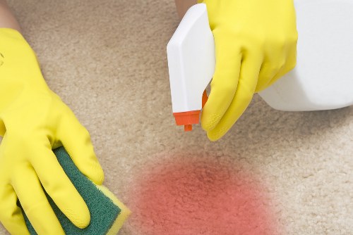 Carpet cleaning staff following safe working practices during a service visit